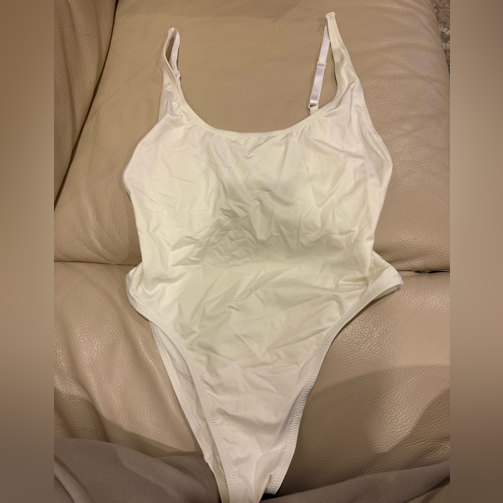 Skims scoop neck one piece swimsuit. Size large, never worn- in Marble (white)